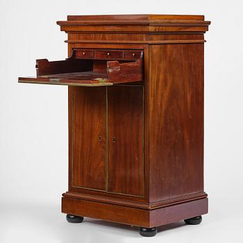 A late Gustavian mahogany column-cabinet, Stockholm, circa 1800.