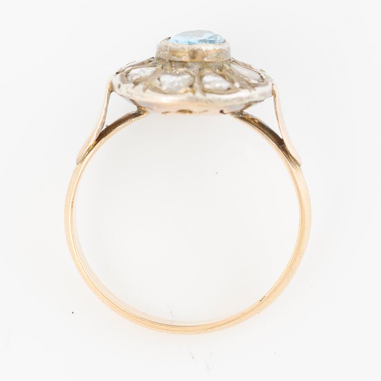 Ring in 14K gold with a faceted topaz and rose-cut diamonds.