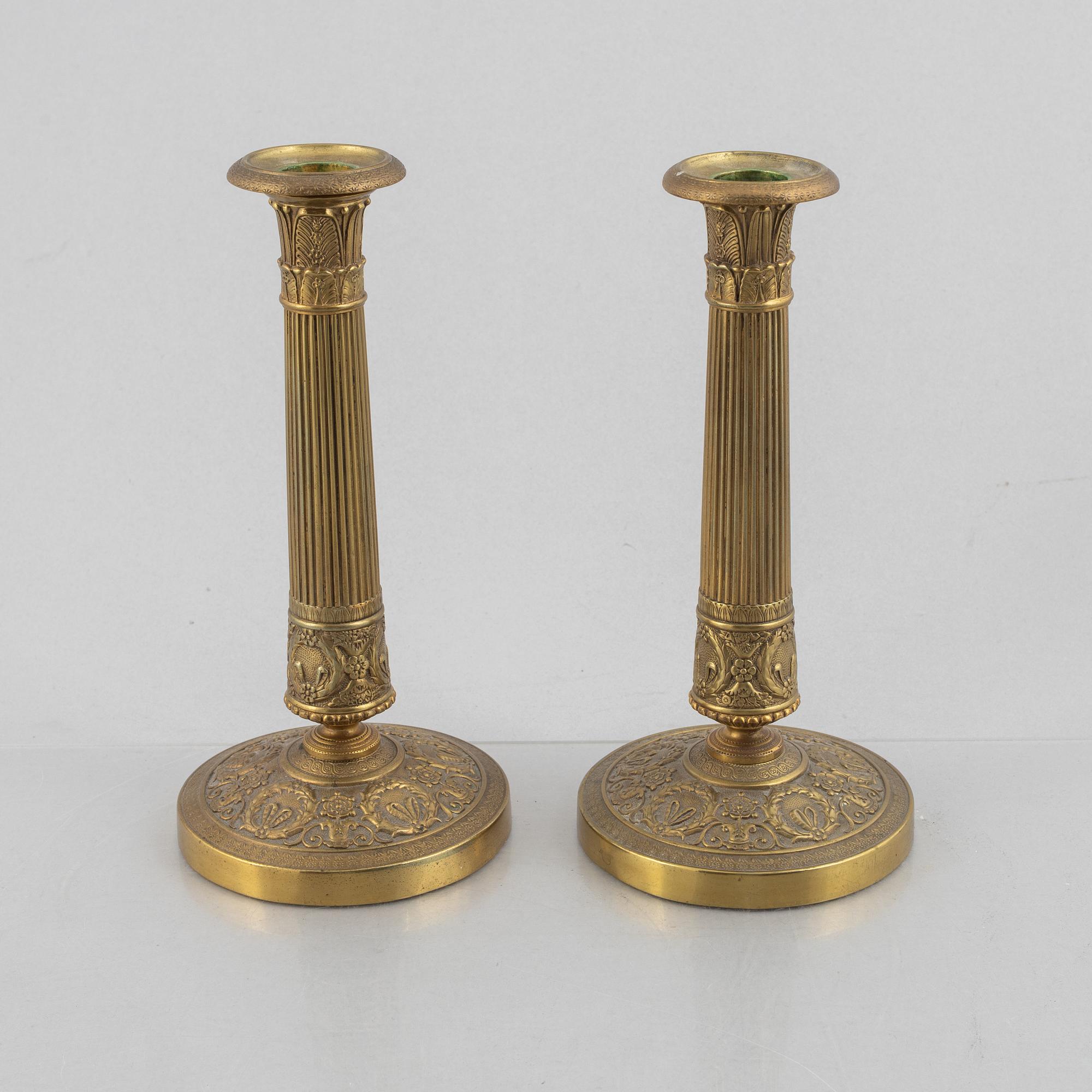 A pair of Empire gilt brass candle sticks, first half of the 20th century.