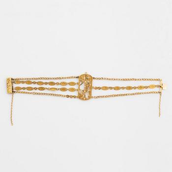 An 18K gold bracelet.