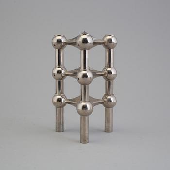 4 different candlesticks, including Ystad Metall, "Nagel" by Werner Stoff.