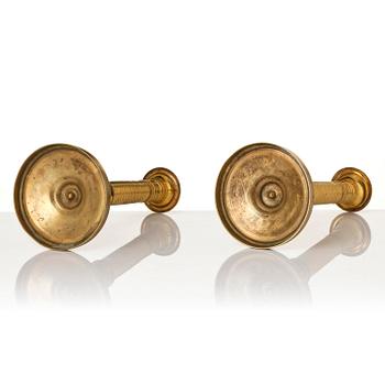 A pair of French Empire ormolu candlesticks, early 19th century.