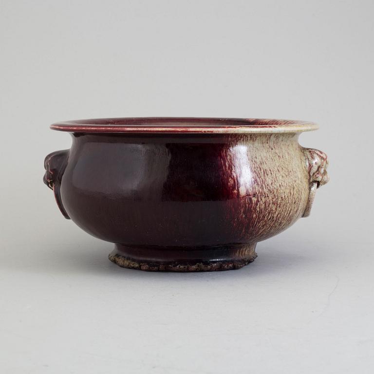 A large red glazed tripod censer, 20th century.