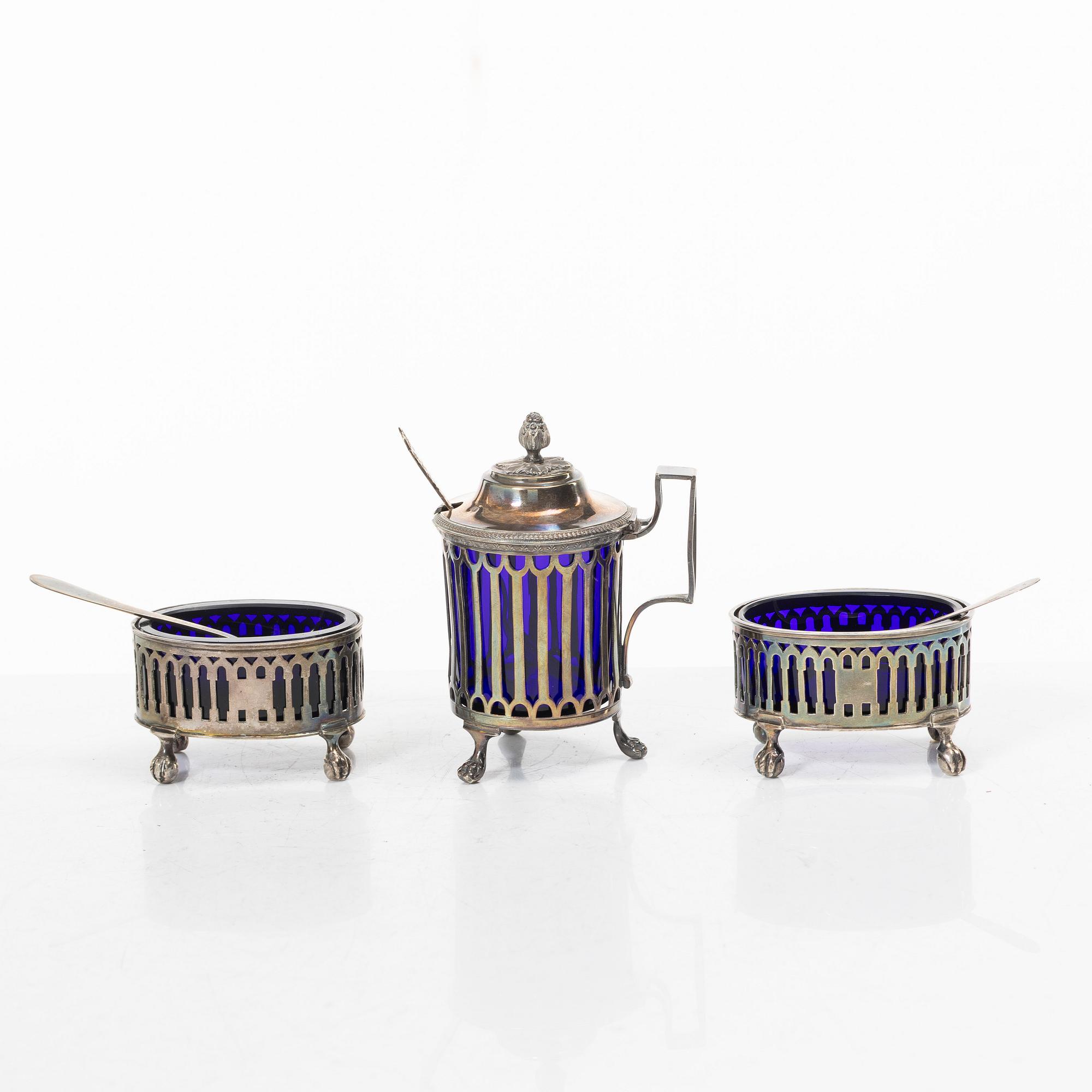 Two silver salt cellars, and a mustard pot, French hallmarks, late 18th Century.