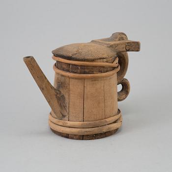 AN 18TH CENTURY WOODEN JUG.