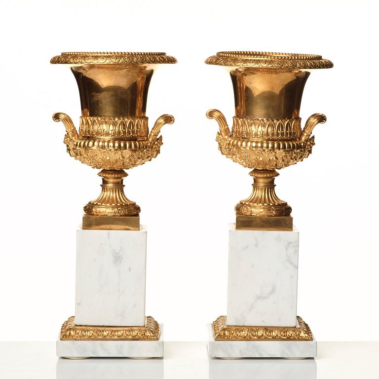 A pair of French 19th century gilded urns.