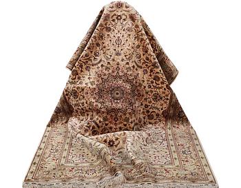 A carpet, Tabriz, with silk warp, c. 297 x 197 cm.