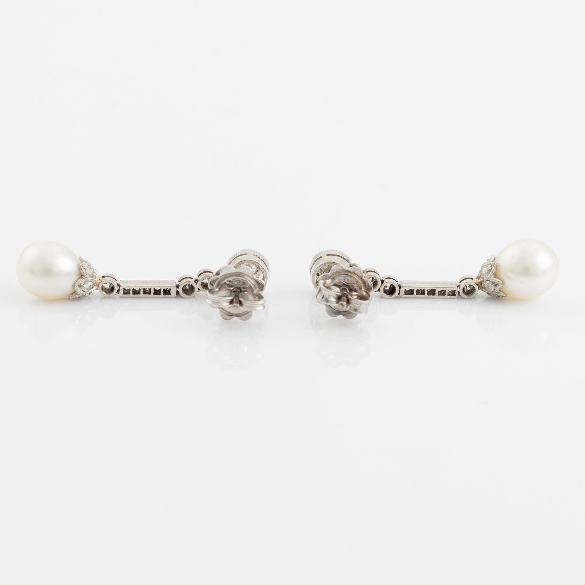 A pair of platinum pearl earings.