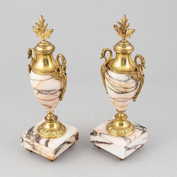 A pair of gilt brass and quartzite decorative urns, circa 1900.