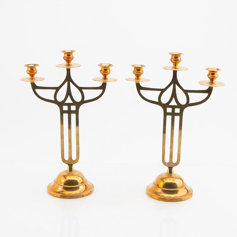 A öair of brass candelabras 20th century.