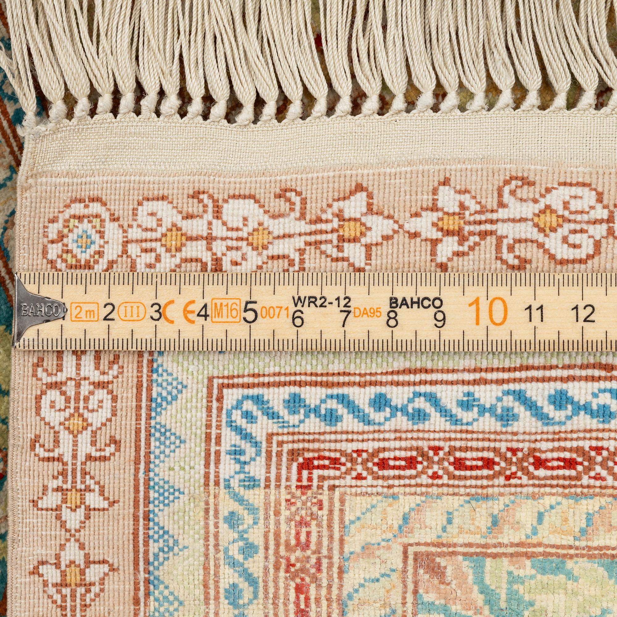 A semi-antique silk Hereke, c. 92 x 61 cm.