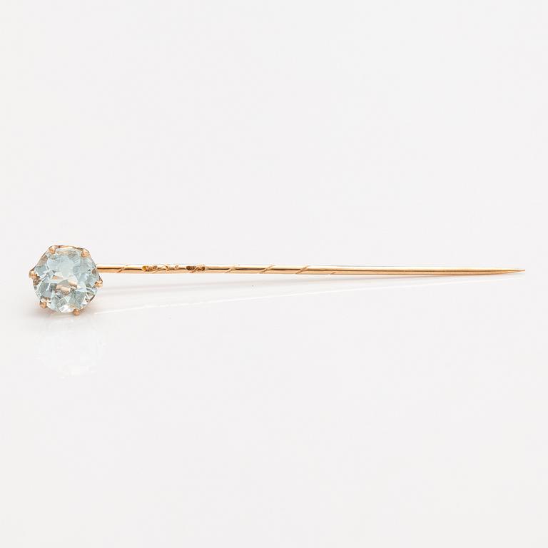 A 14K gold tiepin with a aquamarine.