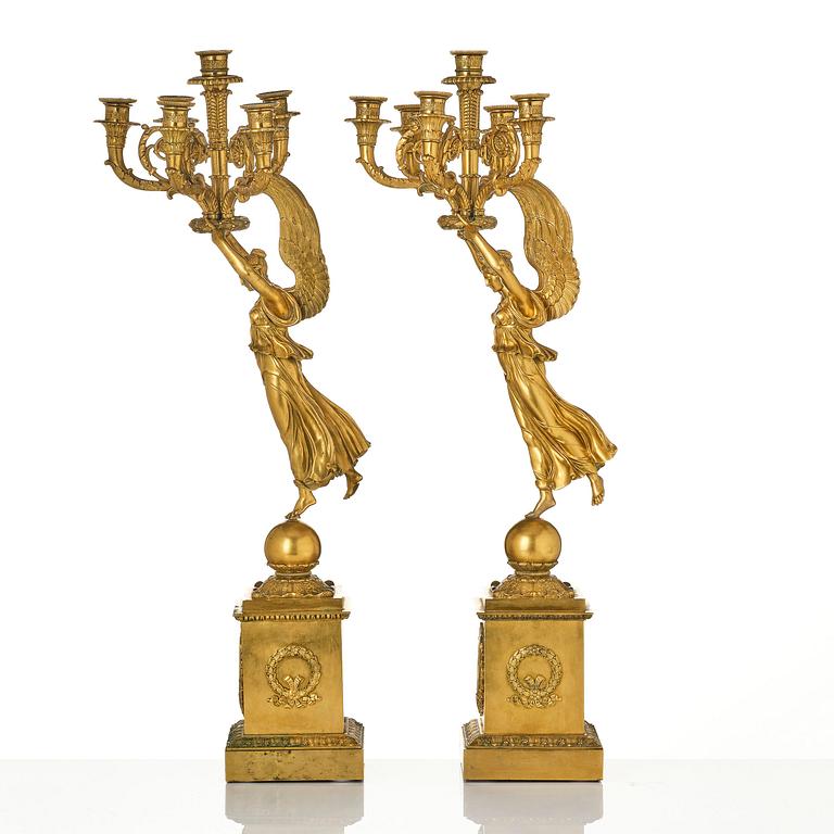 A pair of six-branch gilt bronze Empire candelabra, Paris, early 19th century.