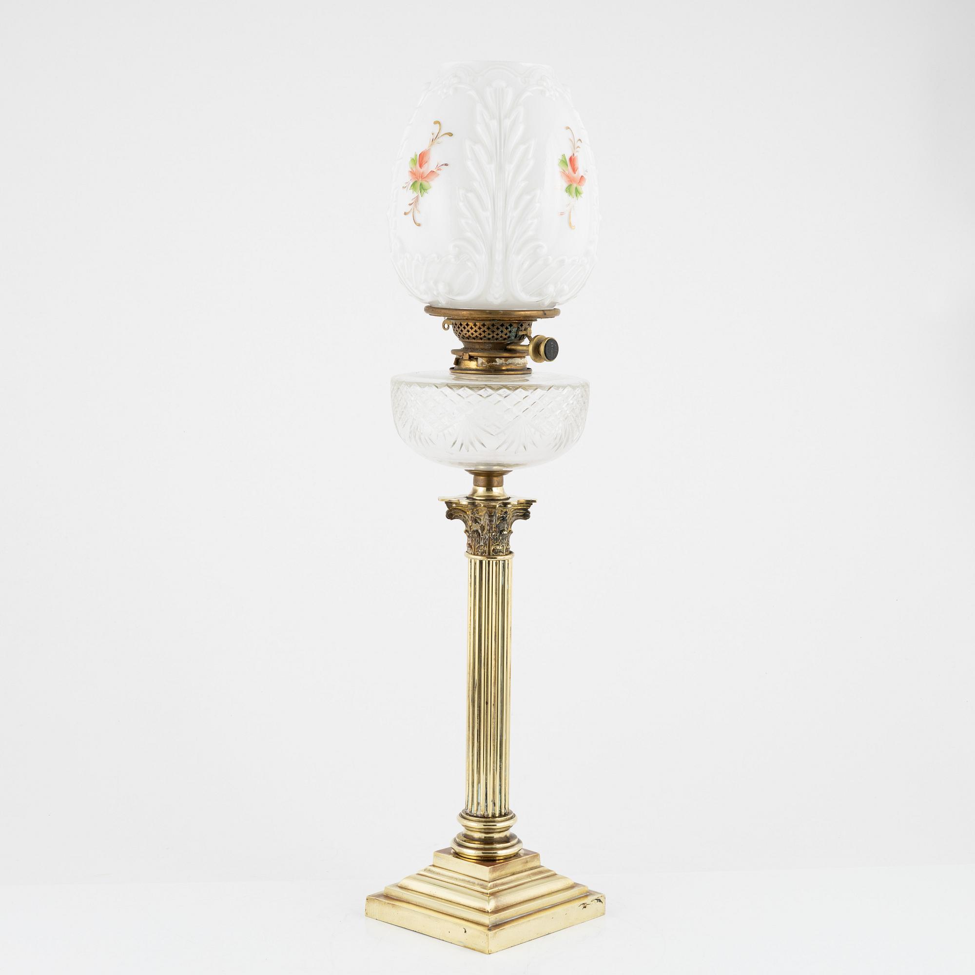 A brass and glass column shaped paraffin lamp, end of the 19th Century.