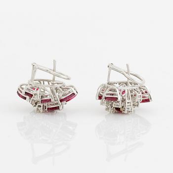 A pair of 18K white gold earrings set with faceted rubies and round brilliant-cut diamonds.