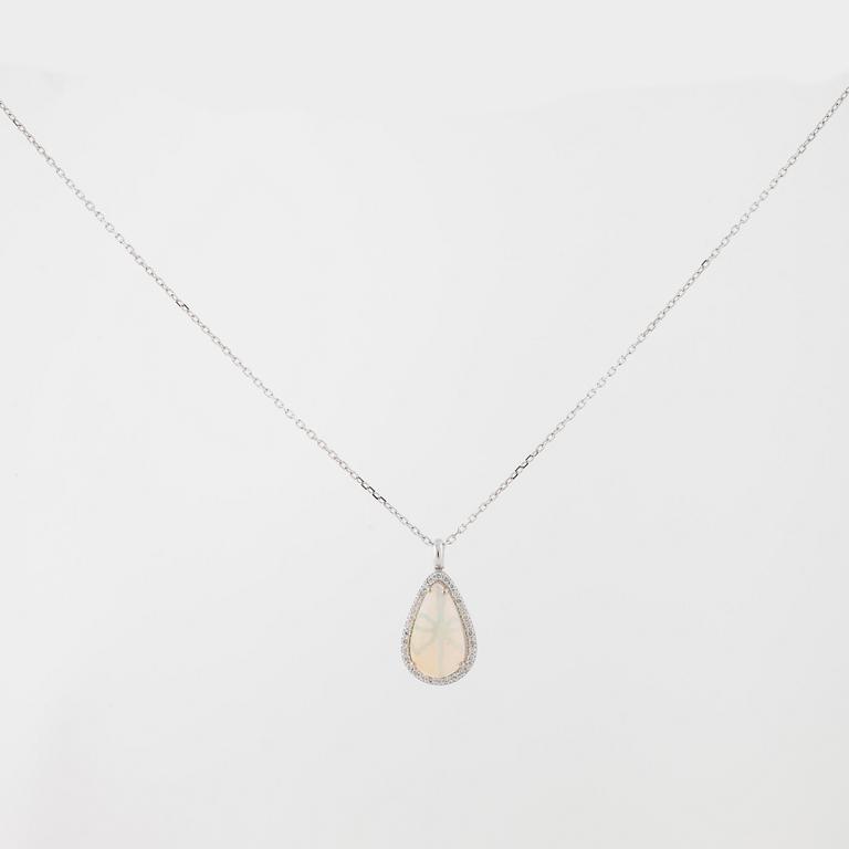 A cabochon cut white opal and brilliant cut diamond pendant.