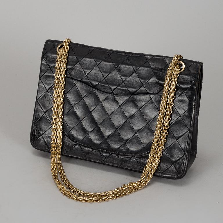 CHANEL, a quilted black leather 'Double Flap Bag'.