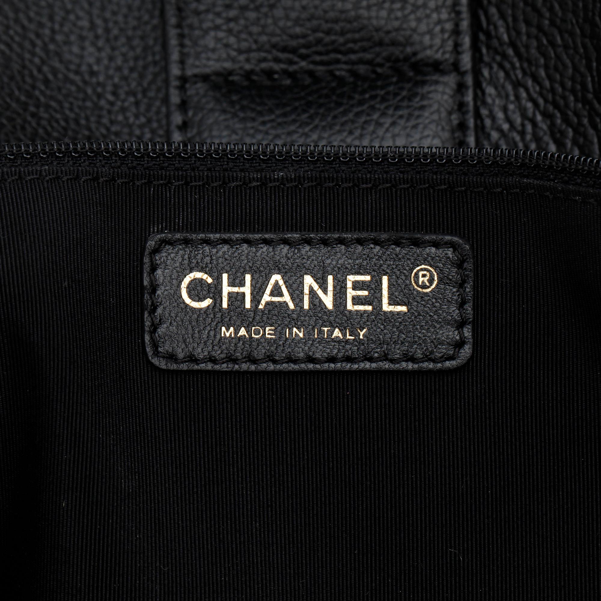 CHANEL,  a black leather bag.