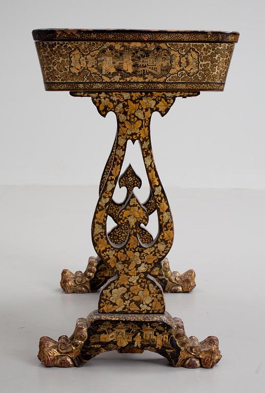 A gold and black lacquer sewing table, Qing dynasty, ca 1800.