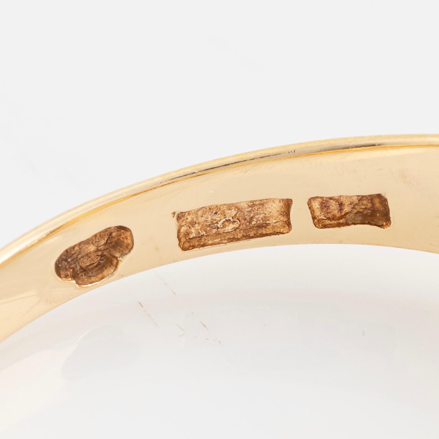 Ring, with faceted white stone.