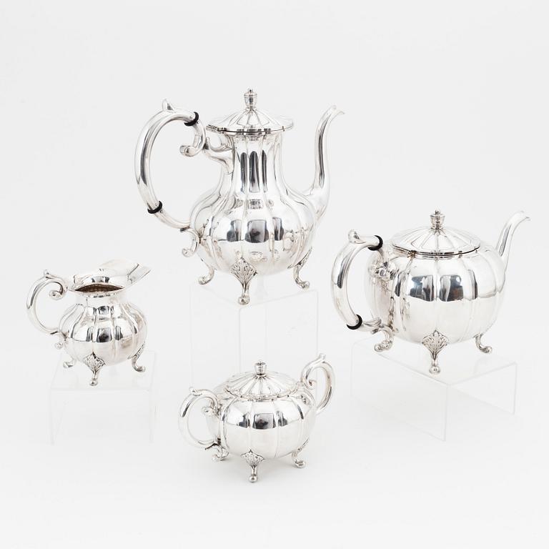 A rococo style sterling silver teapot, coffee pot, creamer and sugar bowl.
