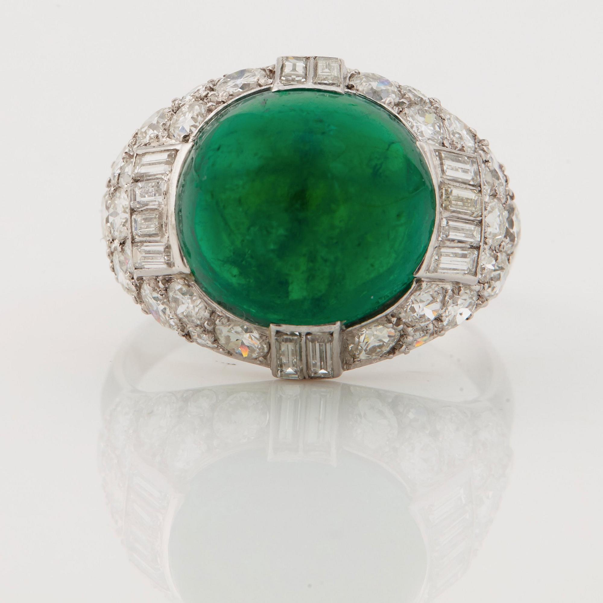 A cabochon-cut emerald, baguette, single and brilliant-cut diamond ring.