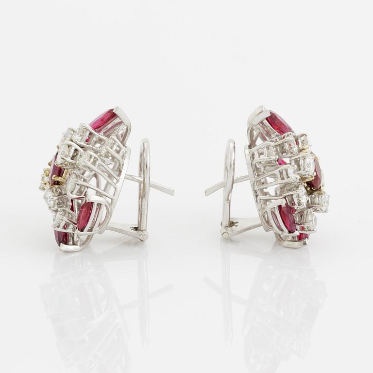 A pair of 18K white gold earrings set with faceted rubies and round brilliant-cut diamonds.