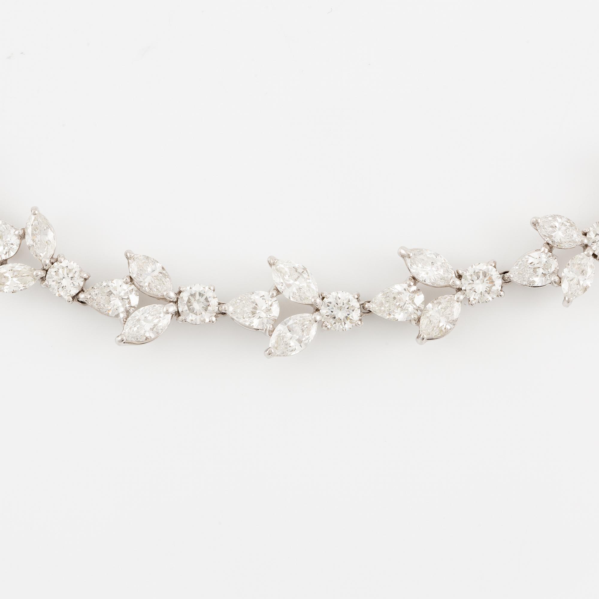 A platinum necklace set with navette-, pear- and round-brilliant-cut diamonds.
