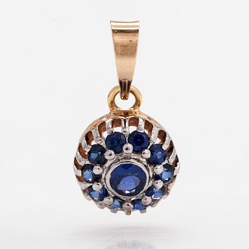 A 14K gold pendant with sapphires.