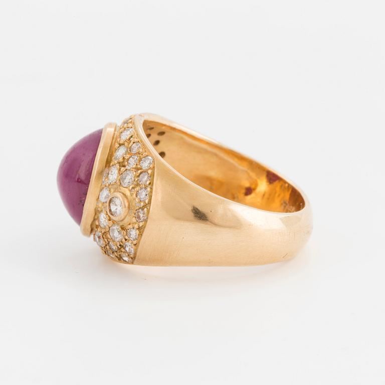 A cabochon cut opaque ruby and brilliant cut diamond ring.