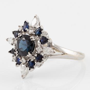 Ring 18K white gold with dark sapphires, pear-shaped and brilliant-cut diamonds.