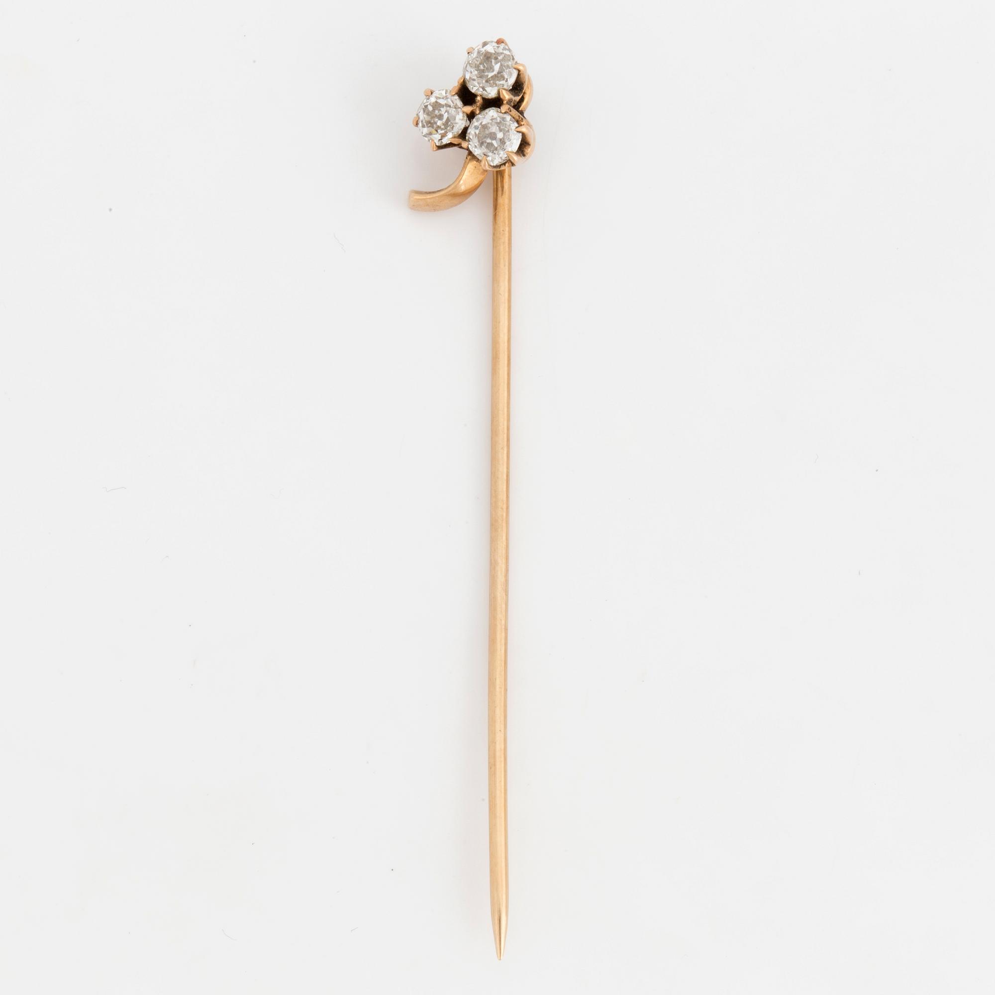 A TIE-PIN, 14K gold with three old cut diamonds.
