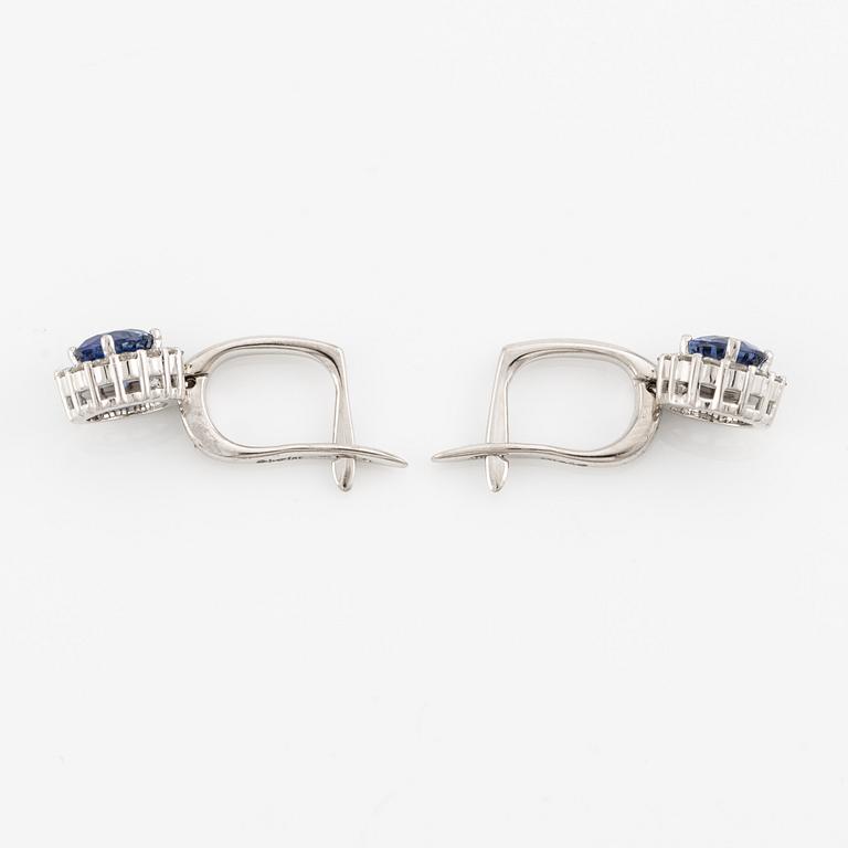 A pair of 14K gold earrings with faceted sapphires.
