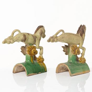 A set of two green and yellow glazed roof tiles figures of flying horses, Qing dynasty.