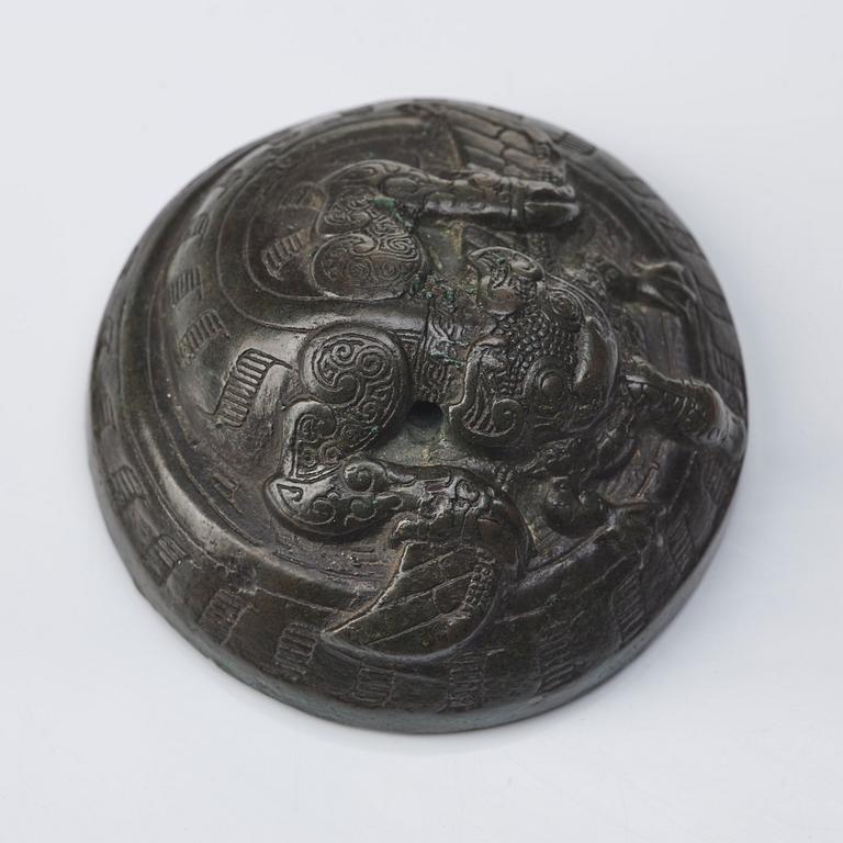 A bronze dragon a and bird weight, Warring states (475–221 BC).