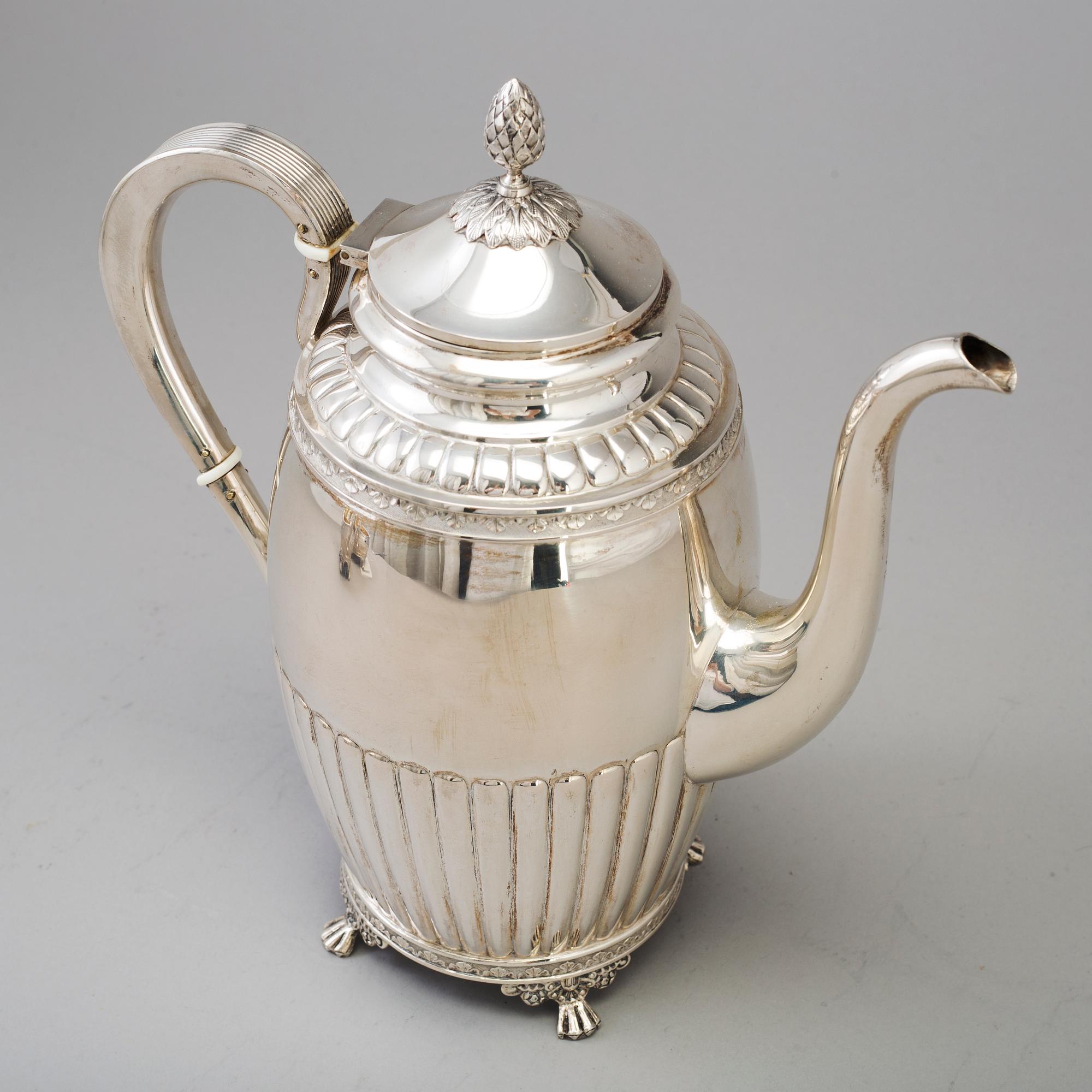 A 3 part silver coffee service dated 1919.