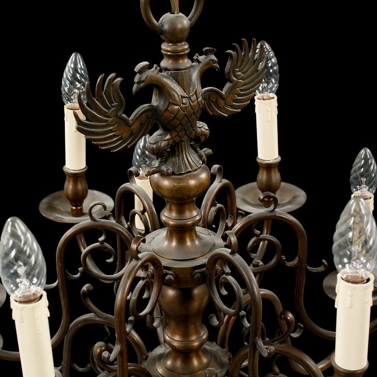 A patinated brass chandelier, first half of the 20th century. Height excl. chain ca 75 cm.