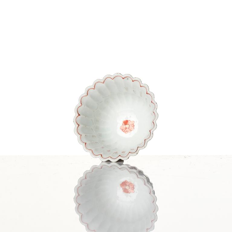 A Chinese iron red porcelain cup with saucer and a small famille verte dish, Qing dynasty, Kangxi (1662-1722).