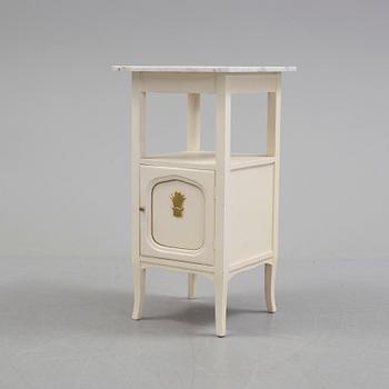 A early bedside table with marble top.