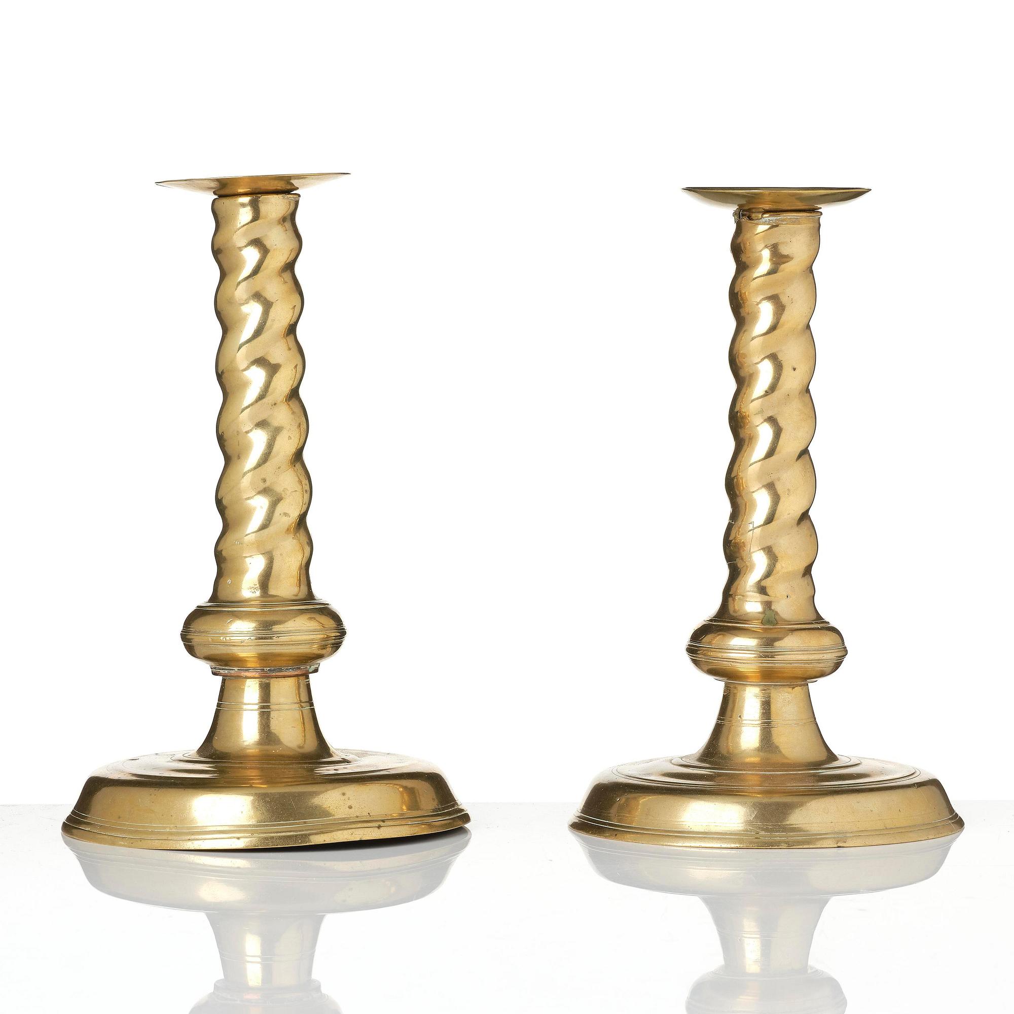 A pair of Northern European cast brass baroque candlesticks, circa 1700.