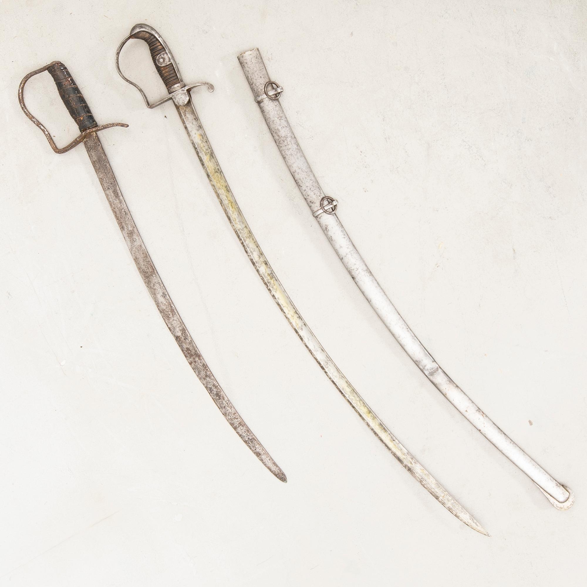 A German sabre with scabbard and a cutlass.