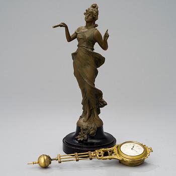 A 1930s Junghans swinger clock with girl sculpture.