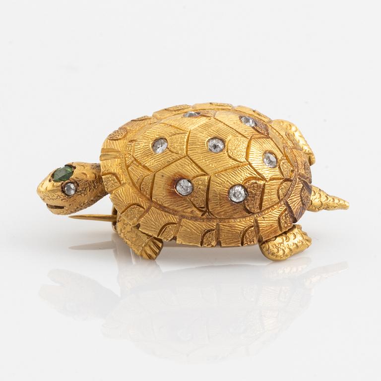 A brooch in the shape of a turtle.