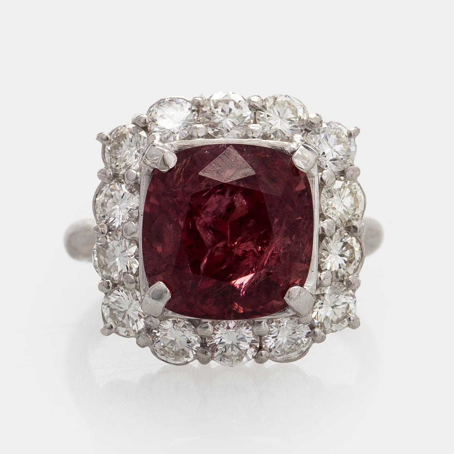 A platinum ring with spinel and brilliant cut diamonds.