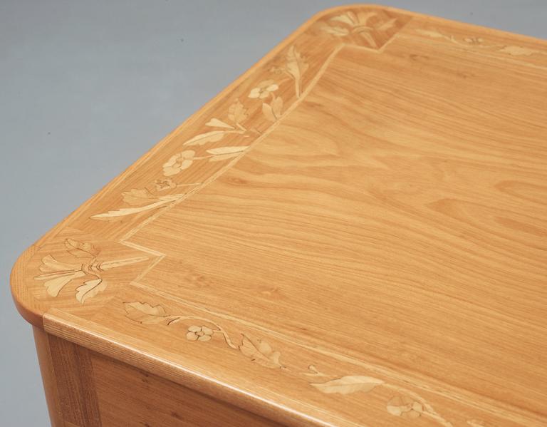 A Carl Malmsten elm table, the top with inlays of different kinds of woods, Sweden 1941-42.