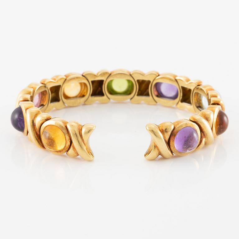 Bracelet in 18K gold set with cabochon-cut citrine, amethyst, pink tourmaline, peridot, and aquamarine.
