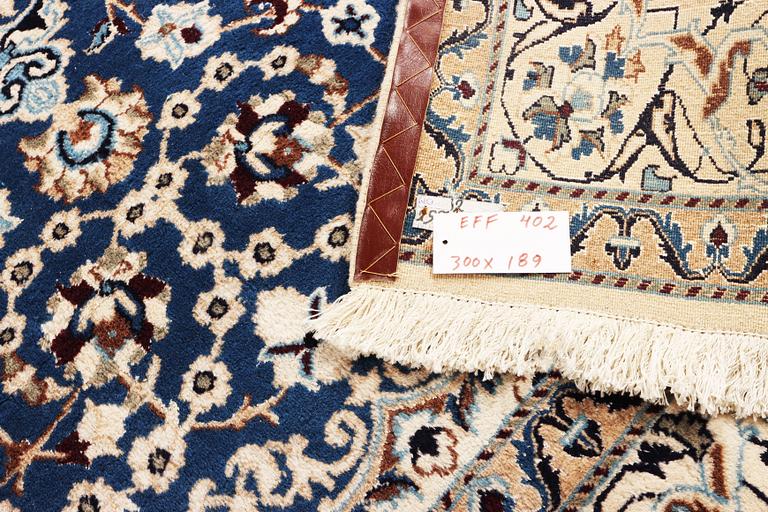 A Nain carpet, part silk, 9 laa, c. 300 x 189 cm.