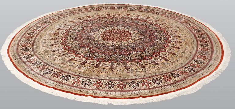 An Oriental silk rug, diameter 256 cm.