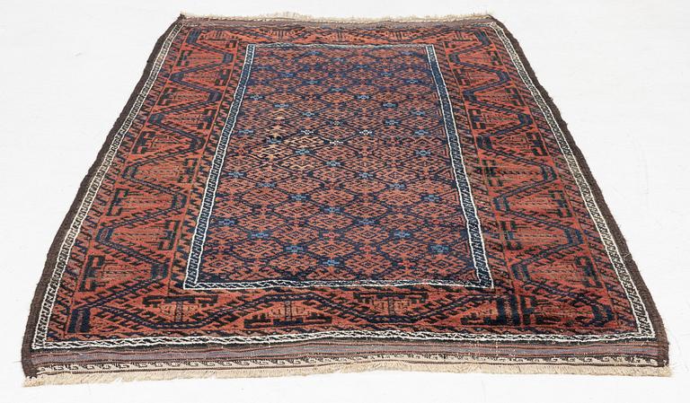 A semi-antique rug, baluch, including flat weave ca. 216 x 110 cm.