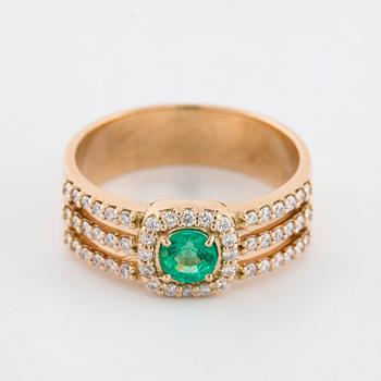 A faceted emerald and brilliant cut diamond ring.